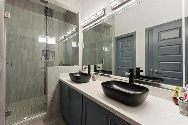 a bathroom with a double vanity sink and a mirror