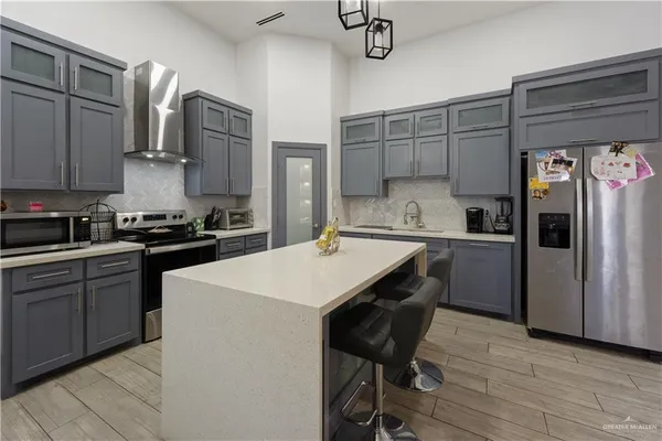 a kitchen with a refrigerator a sink and cabinets