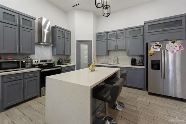 a kitchen with a refrigerator a sink and cabinets