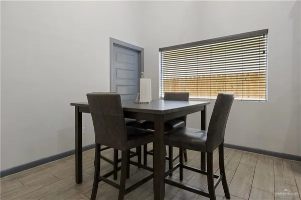 a view of a dining room with furniture and wooden floor