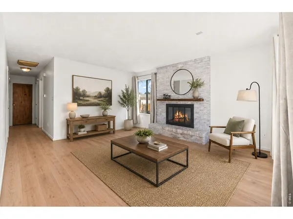 a living room with furniture a fireplace and a flat tv screen