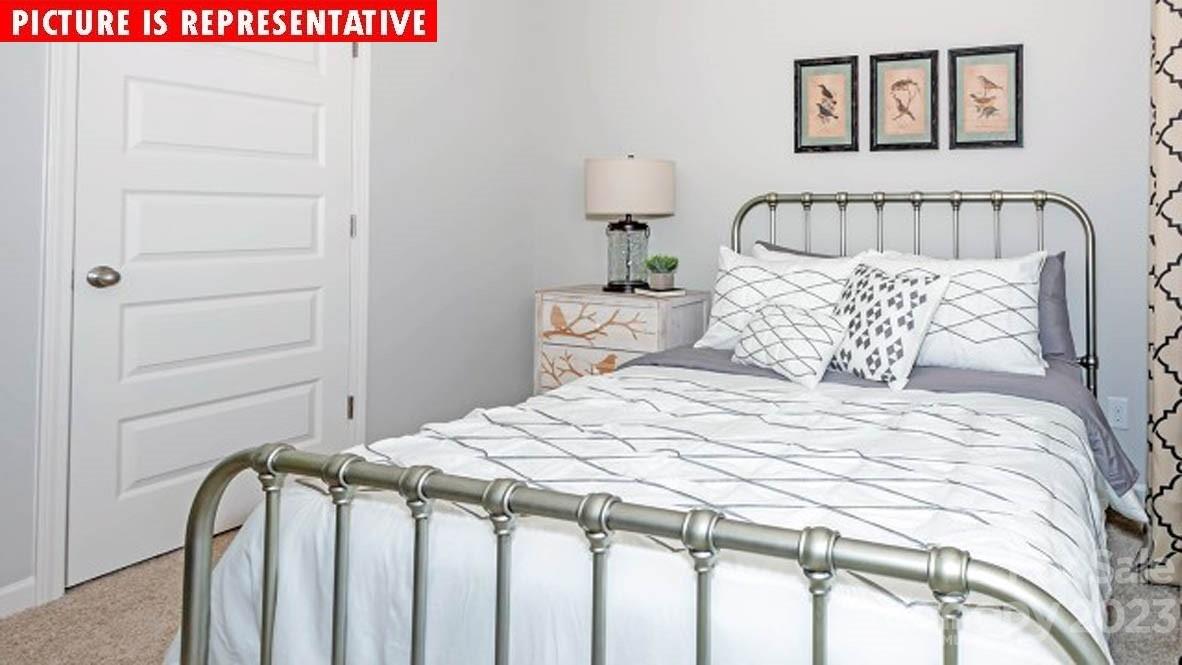 2147 Vanderlyn Street Monroe, NC 28112 - Photo 16 of 22 a bedroom with a bed and a table in it