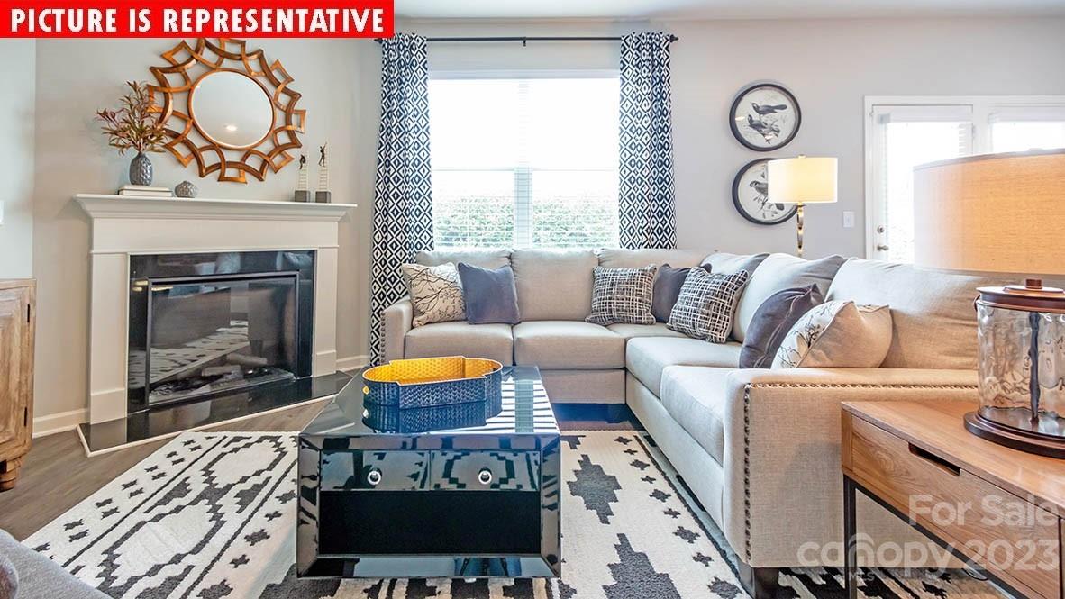 2147 Vanderlyn Street Monroe, NC 28112 - Photo 10 of 22 a living room with furniture a fireplace and a table
