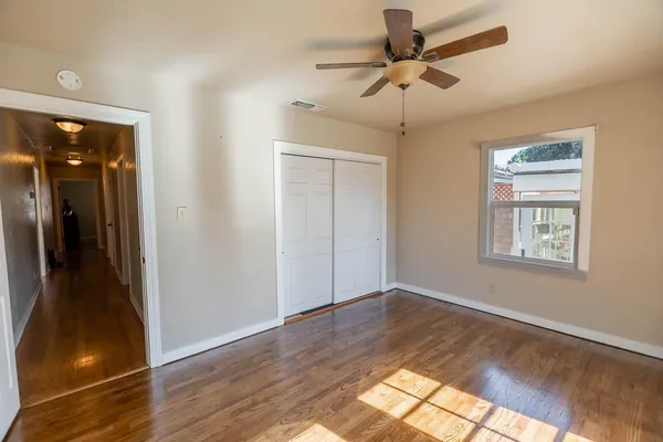 a view of livingroom with hardwood floor and a ceiling fan