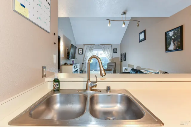 a bedroom with a bed and a flat tv screen on dresser