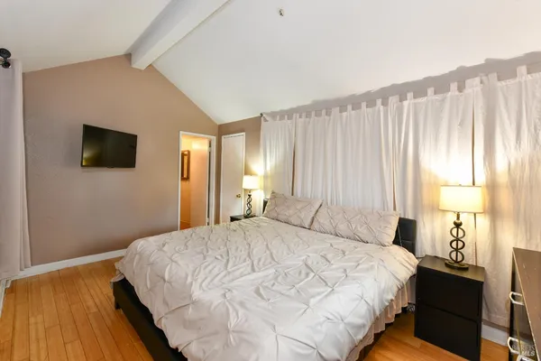 a bedroom with a bed and a window