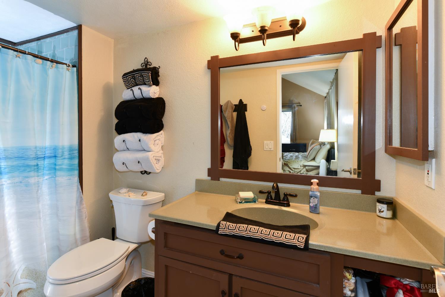 7755 Camino Colegio Rohnert Park, CA 94928 - Photo 14 of 26 a bathroom with a granite countertop sink and a mirror