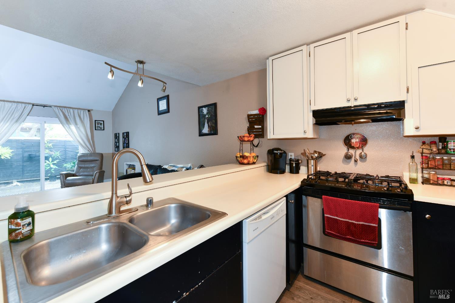7755 Camino Colegio Rohnert Park, CA 94928 - Photo 10 of 26 a kitchen with kitchen island granite countertop a sink stainless steel appliances and cabinets