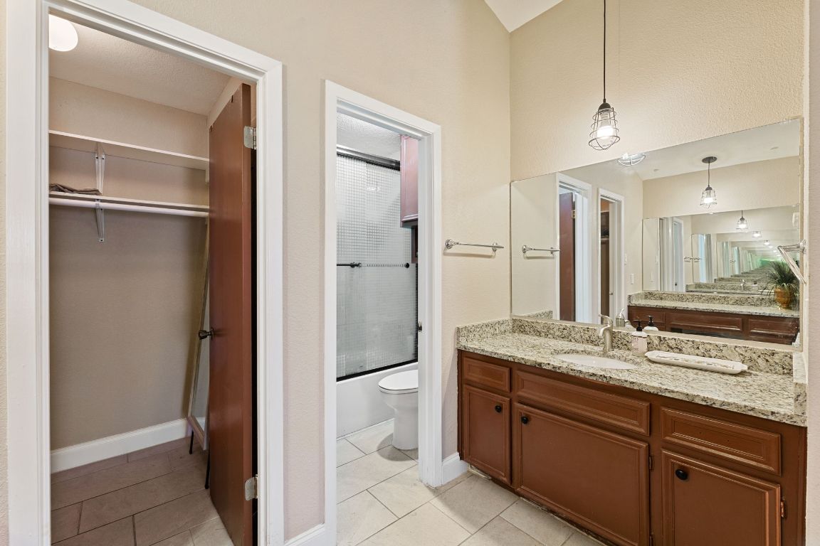 1602 Plateau Ridge Cedar Park, TX 78613 - Photo 13 of 29 a spacious bathroom with a granite countertop sink and a mirror