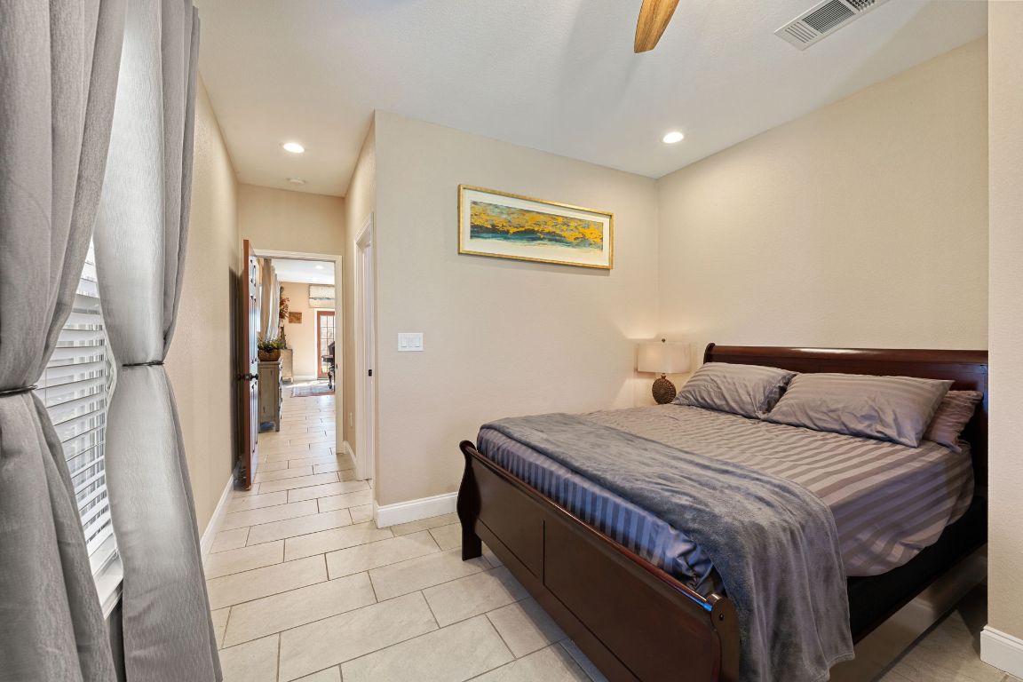 1602 Plateau Ridge Cedar Park, TX 78613 - Photo 17 of 29 a bedroom with a bed and a painting on the wall