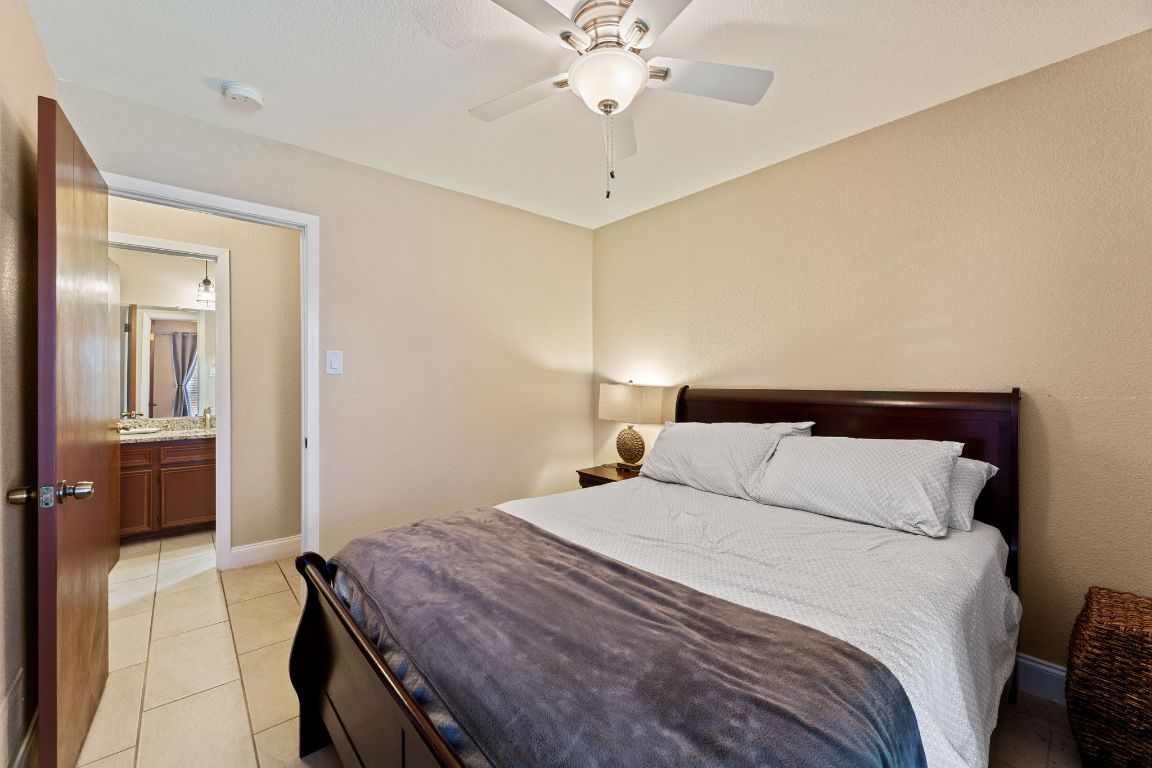 1602 Plateau Ridge Cedar Park, TX 78613 - Photo 20 of 29 a bedroom with a bed and a chandelier