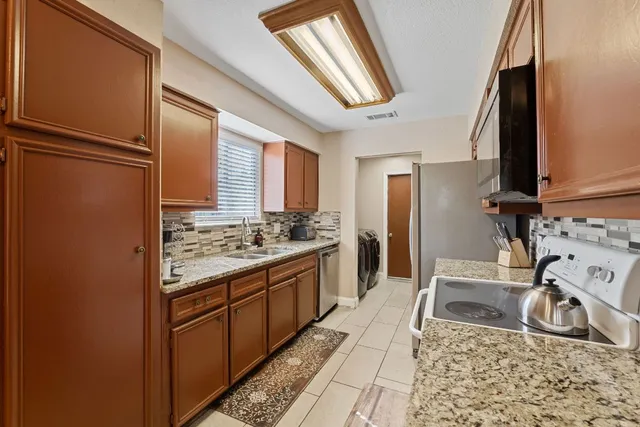 a kitchen with a sink stove and refrigerator