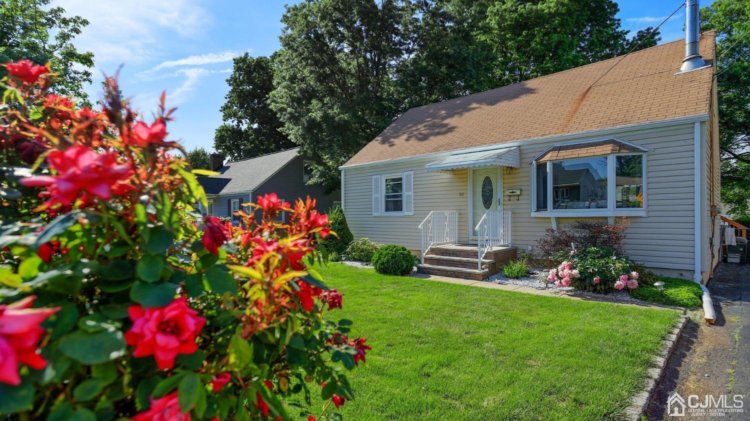 60 Lancaster Road Colonia, NJ 07067 - Photo 1 of 42 a front view of a house with a yard and fountain
