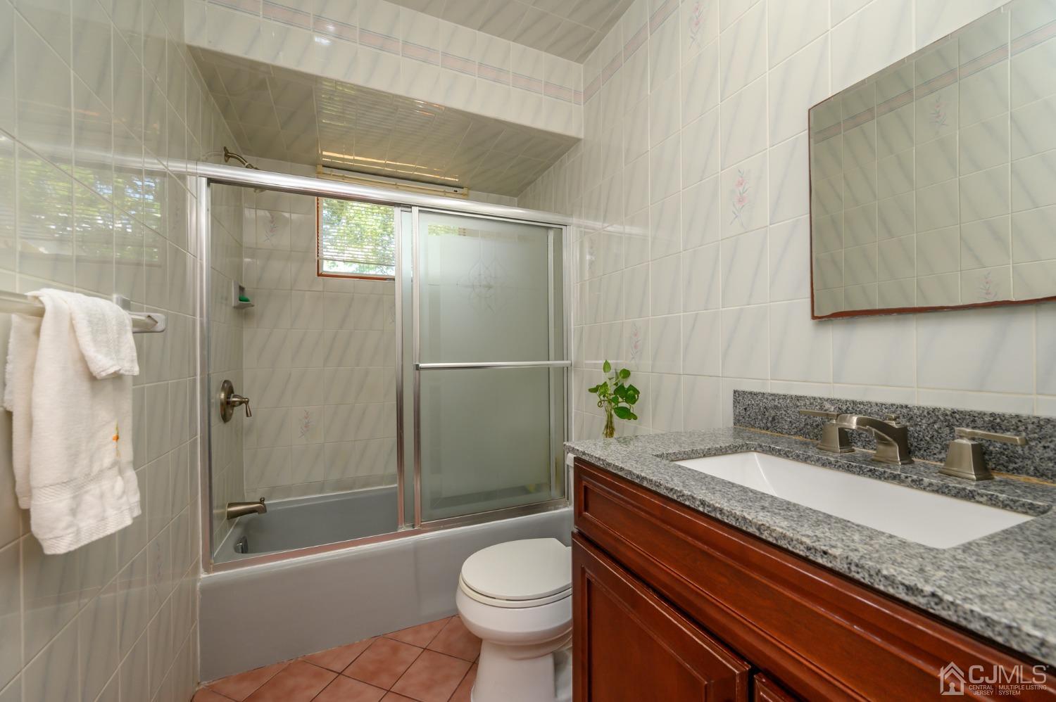 60 Lancaster Road Colonia, NJ 07067 - Photo 17 of 42 a bathroom with a granite countertop sink toilet and shower