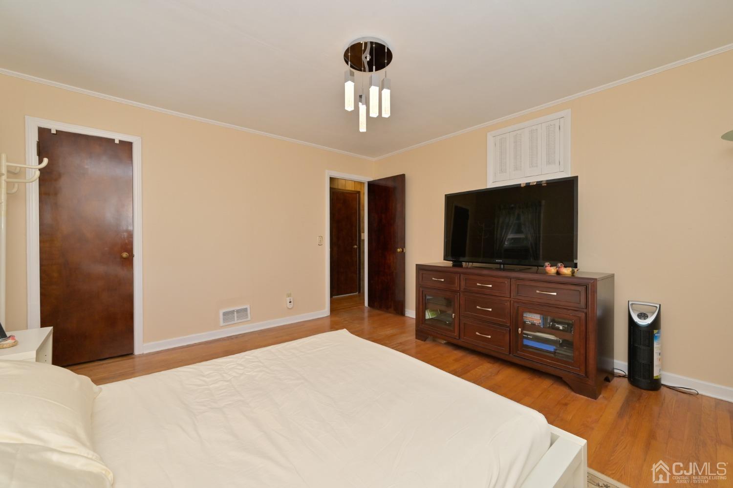 60 Lancaster Road Colonia, NJ 07067 - Photo 20 of 42 a bedroom with a bed and a flat screen tv