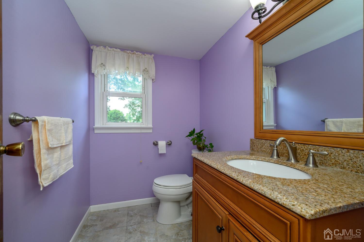 60 Lancaster Road Colonia, NJ 07067 - Photo 36 of 42 a bathroom with a granite countertop toilet sink and mirror