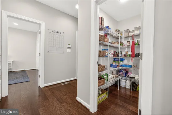 a dining table with wooden floor a chandelier a wooden table and chairs