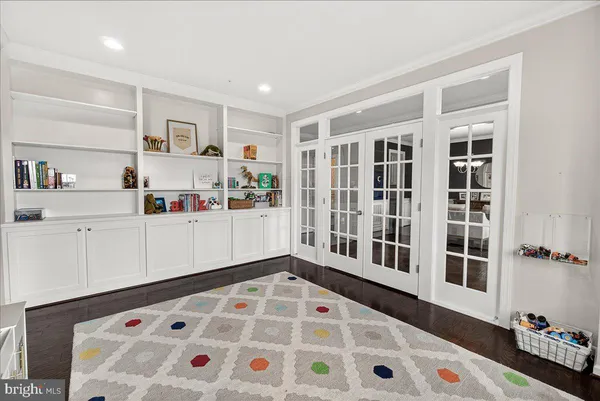 a bedroom with a bed lamp and a large window