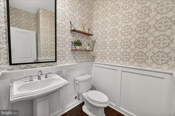 a bathroom with a sink a toilet and shower curtain