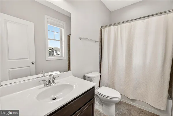 a view of walk in closet with clothes