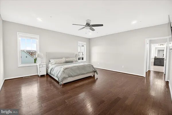 a bathroom with a granite countertop sink a mirror and a shower