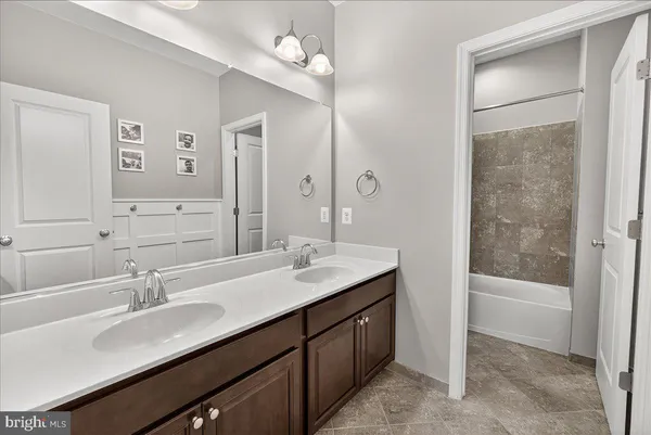 a view of walk in closet with clothes