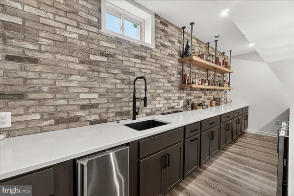 a front view of a house with a yard and trees
