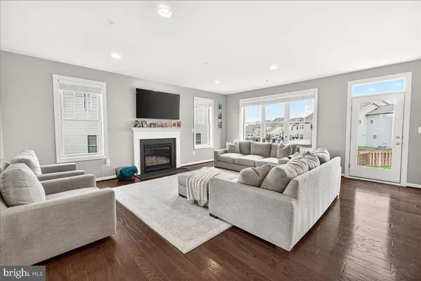 a living room with furniture flat screen tv and a fireplace