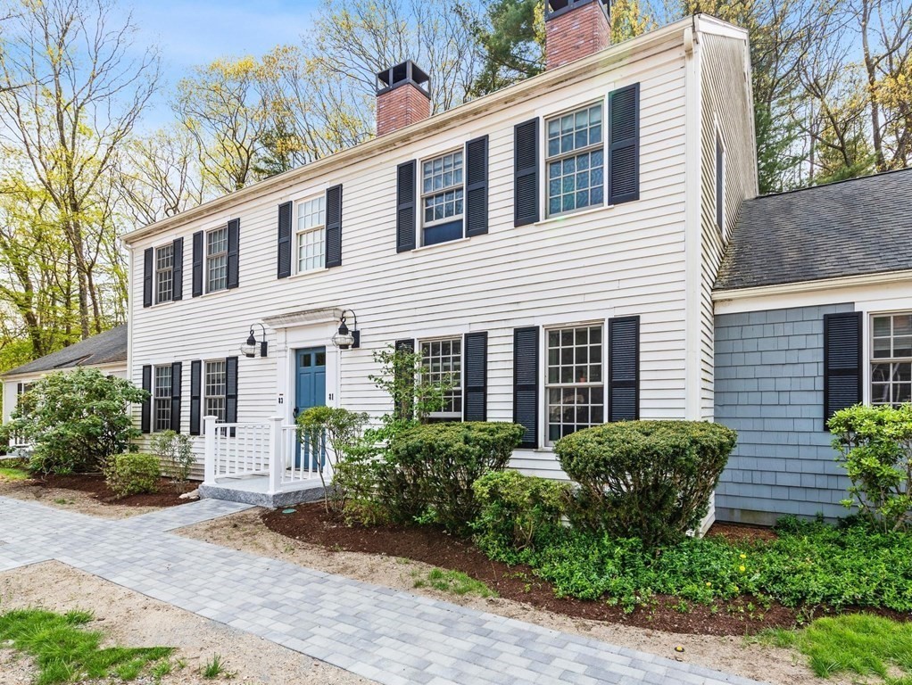 a view of a house with a yard and sitting area
