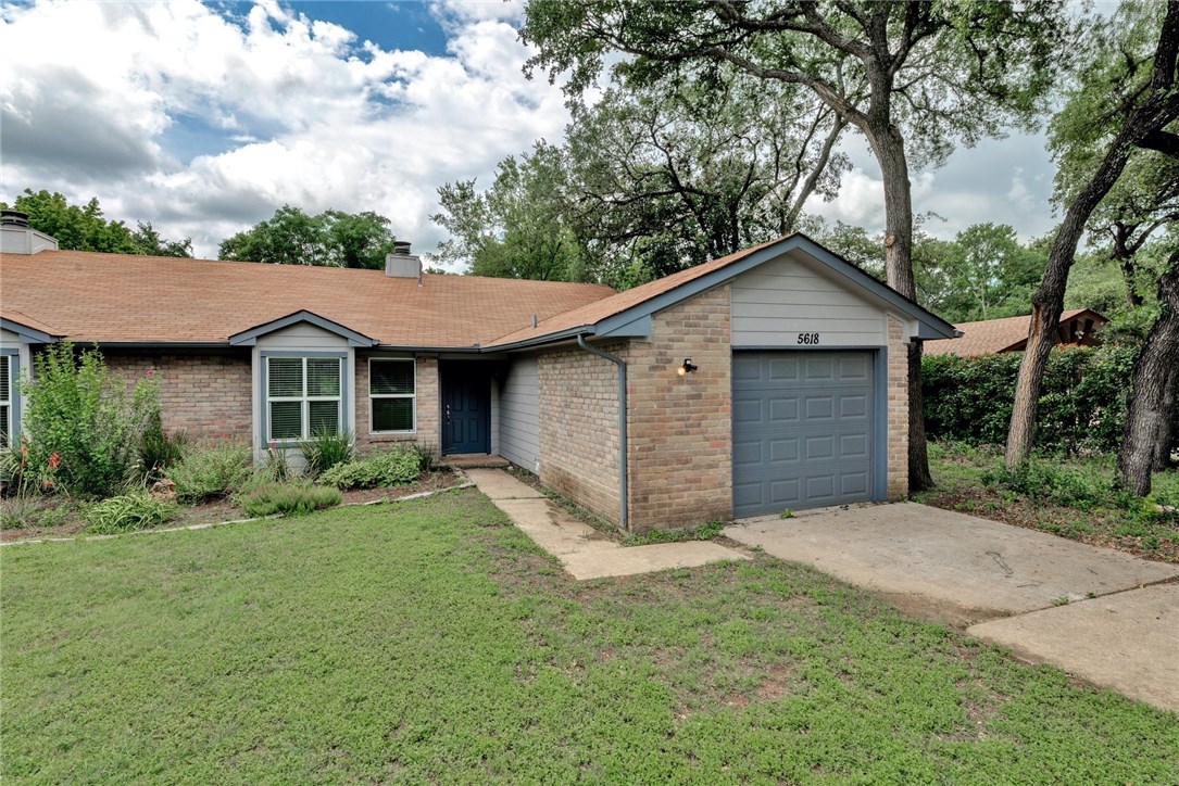 5616 Oak Boulevard, Unit B Austin, TX 78735 - Photo 1 of 1 a view of a yard in front of a house with large windows