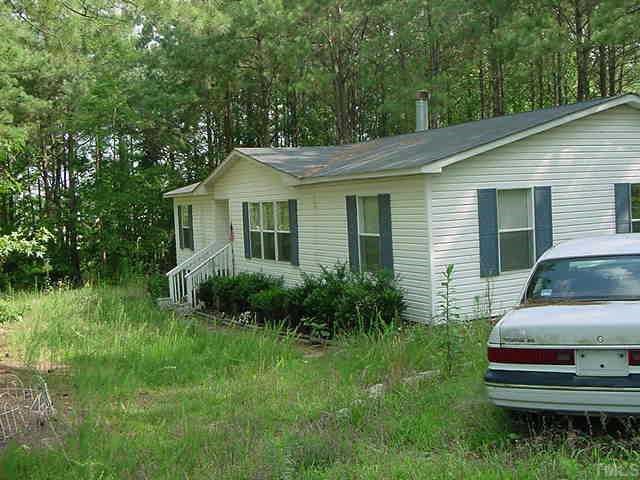 2495 Pilot-Riley Road Zebulon, NC 27597 - Photo 1 of 1 a front view of a house with a garden