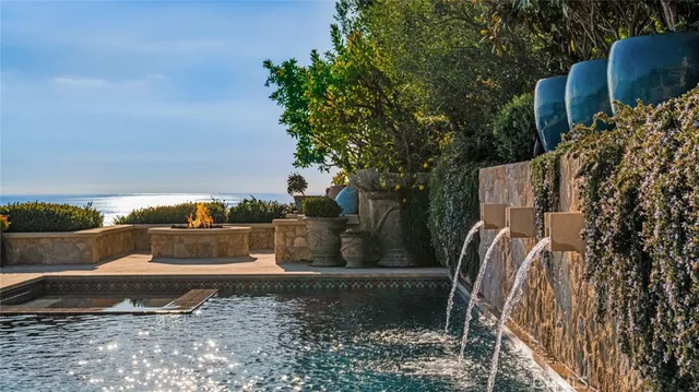 a view of a house with pool and chairs