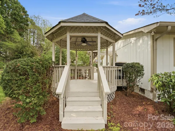 a balcony with wooden floor table and chairs