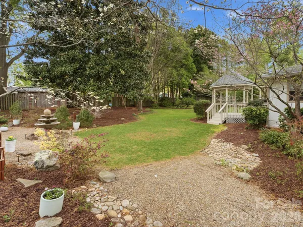 a backyard of a house with table and chairs