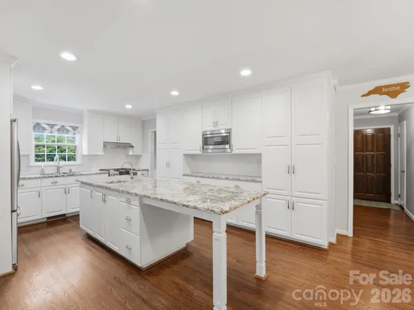 a kitchen with a refrigerator sink and cabinets