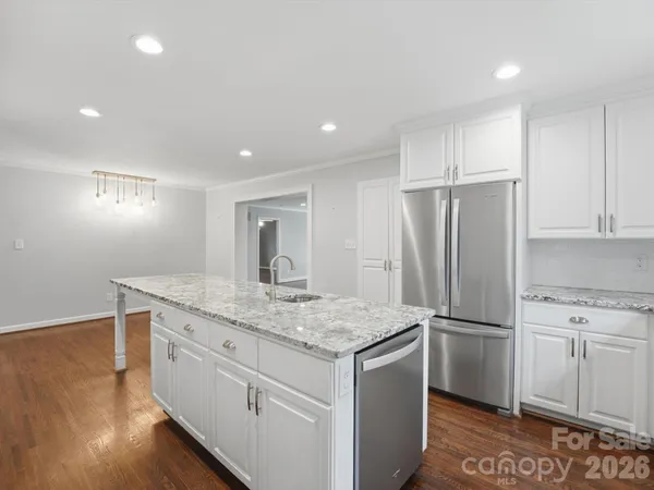 a kitchen with granite countertop a sink and a stove