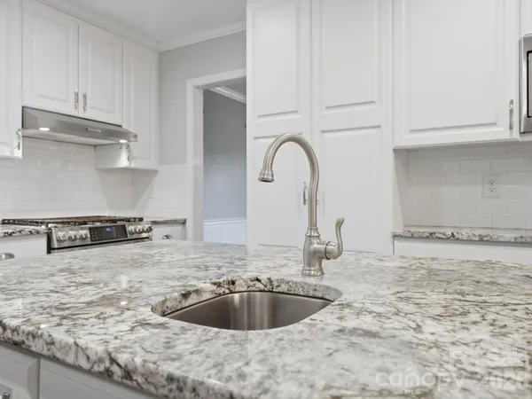 a living room with wooden floor and a fireplace