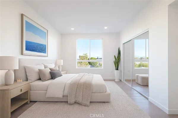 a bedroom with a large bed and a large window