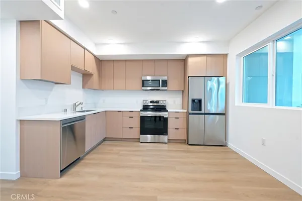 a kitchen with a refrigerator and a sink