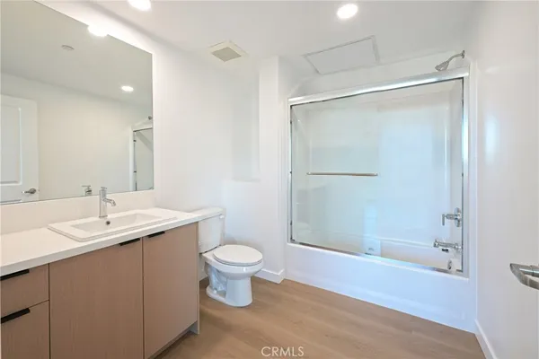 a bathroom with a sink toilet a mirror and shower