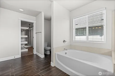 a white bath tub sitting next to a shower