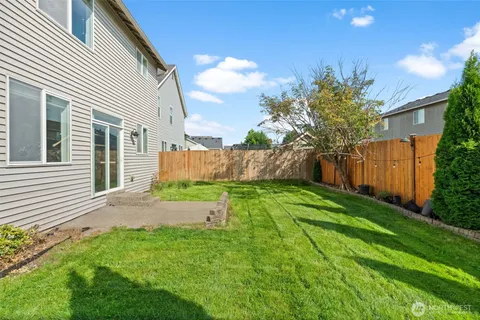 a view of a backyard with wooden fence