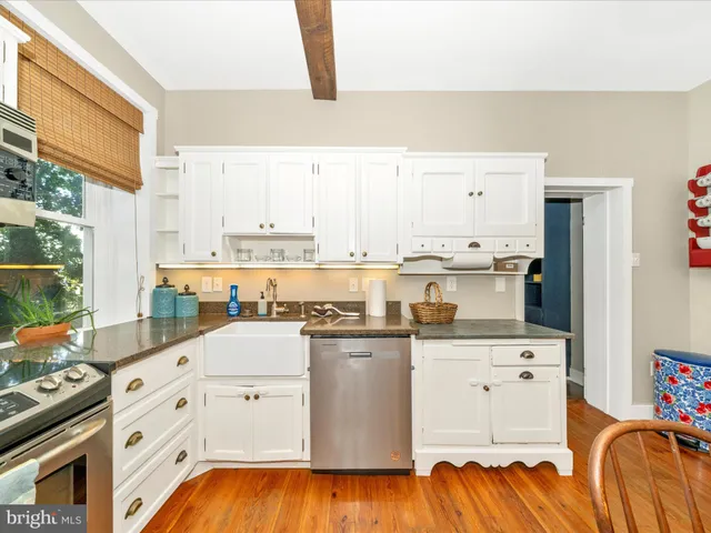 a bedroom with a bed and dresser with mirror