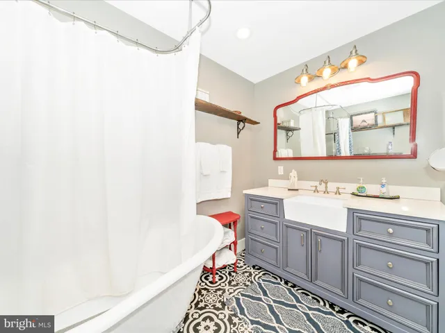 a living room with a bed furniture and a bookshelf