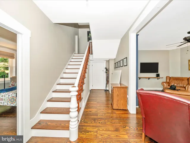 a living room with furniture a ceiling fan and a window