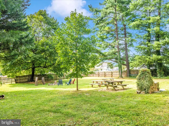 a view of a house with swimming pool and sitting area