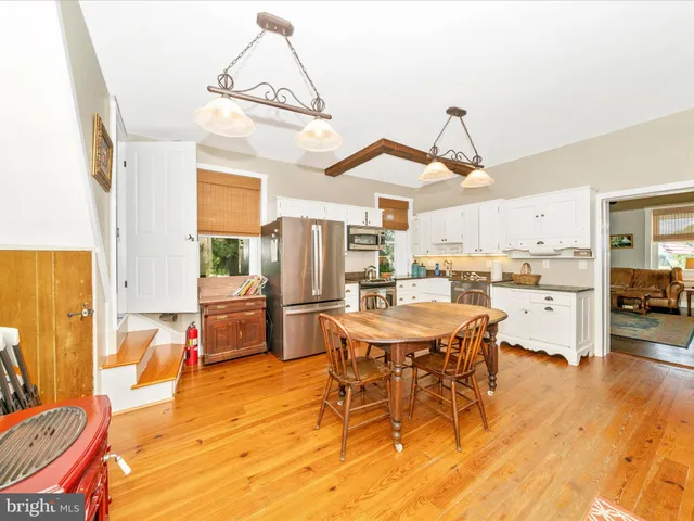 a kitchen with stainless steel appliances granite countertop a stove and white cabinets