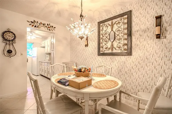 a view of a dining room with furniture and chandelier