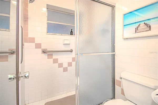 a bathroom with a toilet and a shower