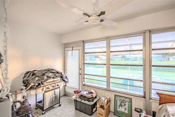 a bedroom with furniture and a large window